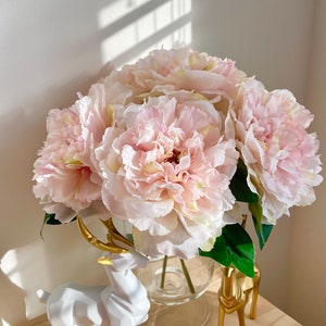 Artificial light pink peony stem with layered blooms and green leaves