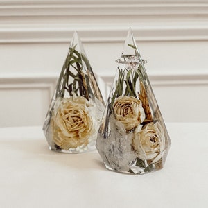 Resin ring holder with dried floral arrangement in a faceted triangular design