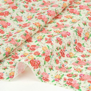 Rosebell floral cotton fabric with pink roses on light background, rolled yardage