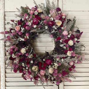 Dried flower wreath with pink and purple blooms and airy dried greenery, round boho style