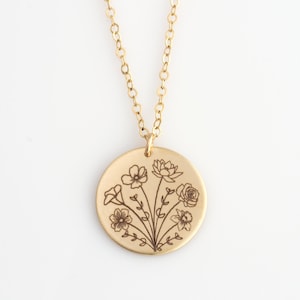 Gold-tone birth flower bouquet necklace with round engraved pendant and thin chain