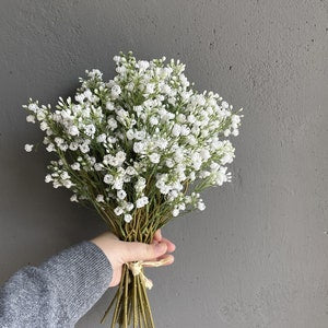 Artificial baby's breath bouquet with small white clustered flowers, tied with twine
