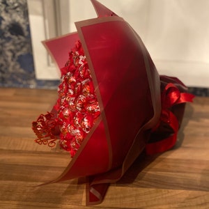 Large Lindt Lindor chocolate and flower bouquet with red ribbon wrap