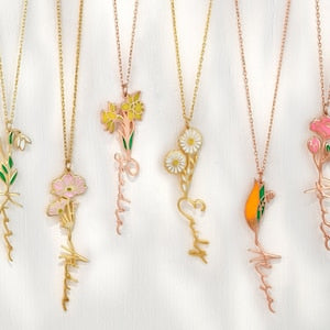 Gold-tone pendant necklace with birth-flower charm on a delicate chain