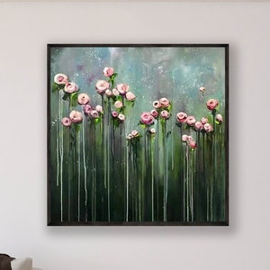 Framed canvas wall art with pink and white flowers and green grass texture
