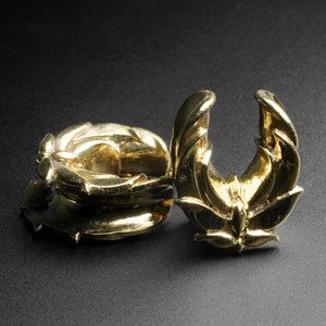 Brass ear stretcher plug with raised lotus flower motif, sculpted saddle design