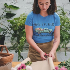 Blue fitted women's tee with front Shih Tzu & Co fresh flower graphic