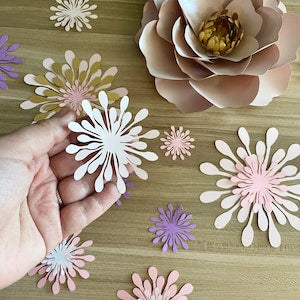 Paper flower center cutouts, white and pastel pink with purple accents