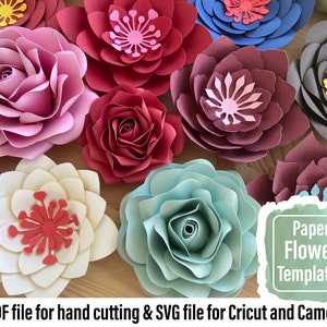 Assorted paper flower wall decor with large layered blooms in red, pink, blue, and cream