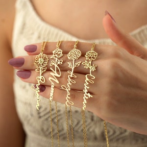 Gold-tone floral name necklace with small tree and flower charm pendants