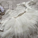 White lace long-sleeve dress with tulle tutu skirt and satin bow detail