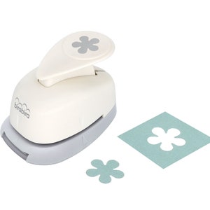 Flower lever-action craft punch with clover flower cutouts and paper