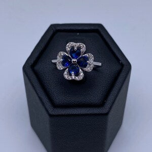 Silver flower ring with sapphire blue stones and pavé accents