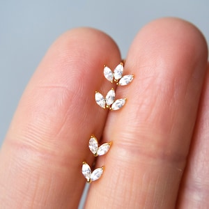 Tiny flower stud earrings with small clear stones, gold-tone setting