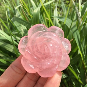 Rose quartz crystal flower sculpture, pink translucent carved petals with spiral center