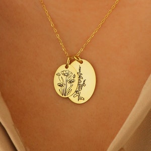 Gold-tone round pendant necklace with delicate flower line-art on a thin chain