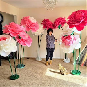 Oversized foam flower decorations with tall stems, pink and white flower heads