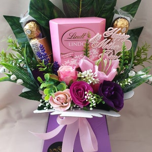 Pink and purple silk flower gift hamper with ribbon bow and Lindt box