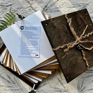 DIY flower press kit with brown press boards, papers, and instruction booklet