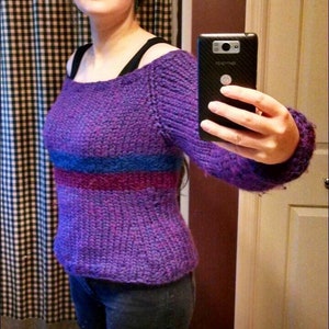Off-shoulder knit sweater in purple with blue and pink stripe bands