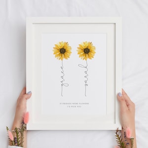 Framed friendship print with two yellow flowers and matching cursive names, white mat