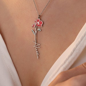 Silver-tone pendant necklace with red flower and dangling script charm