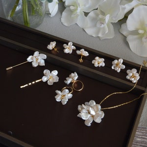 Baroque petal pearl flower necklace with gold-tone chain and dangling blossoms