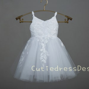 White lace and tulle flower girl dress with sleeveless bodice and gathered skirt