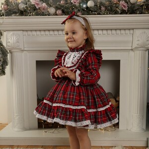 Red and green plaid baby girls dress with white ruffle collar and layered skirt