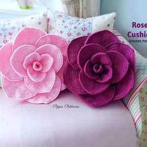 Crochet rose cushion pattern with pink and purple crochet rose appliques