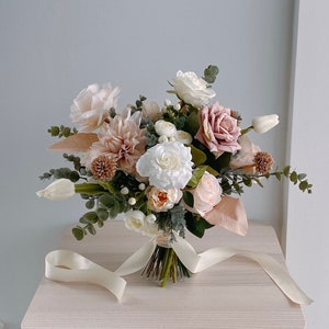 Ivory and blush silk bridal bouquet with assorted roses, greenery, and satin ribbon wrap