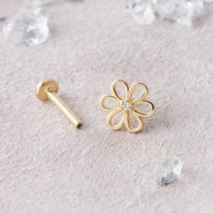 14k gold flower stud earring with small clear gemstone detail