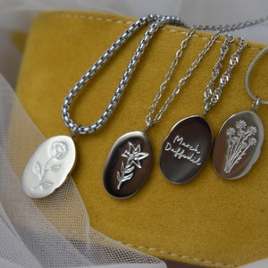 Silver-tone chain necklace with oval birth-flower pendants, white and dark