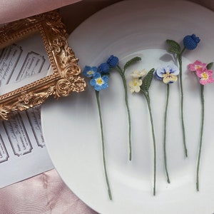 Handmade crochet flower bookmark set with blue and yellow blooms and green stems