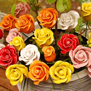 Porcelain ceramic roses with mixed colors on green stems, bouquet-style