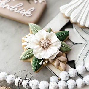 Flower-shaped cookie cutter with clustered petals and leaf accents