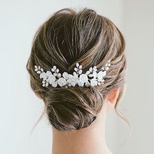 Ivory floral pearl hair comb with small white blossoms and leaf-like pieces