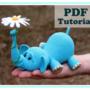 Blue crocheted amigurumi elephant with daisy and small balloon, handmade plush