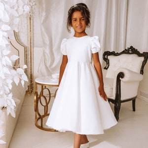 White short-sleeve flower girl dress with gathered waist and A-line skirt