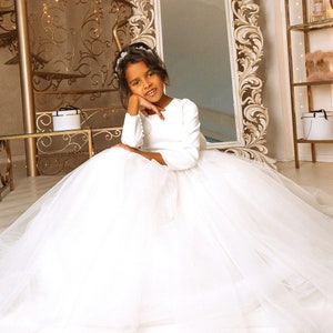 Toddler white tulle flower girl dress with long sleeves, full skirt and bow detail