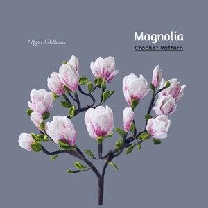 Crochet magnolia flower pattern with pink-and-white blossoms on a branching stem