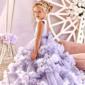 Lavender sleeveless tulle flower girl dress with layered ruffles and bow back