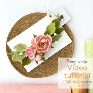 Peony flower crown with pink and green blossoms on a woven headband