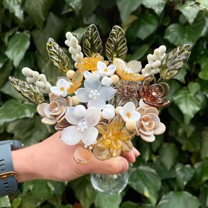 Boho glass flower bouquet with white blossoms and gold leaf accents