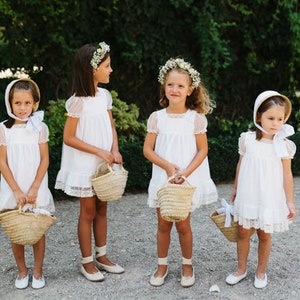 Woven straw flower girl basket with handles, held in front