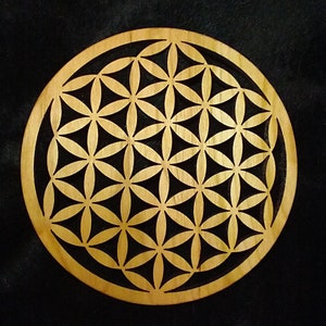 Round wooden coaster with gold engraved flower of life sacred geometry pattern