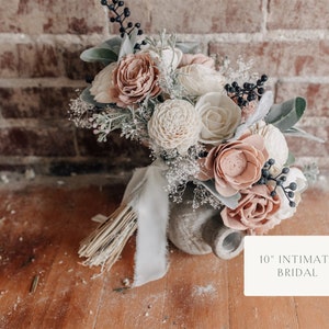 Dusty rose and ivory wood flower wedding bouquet with greenery and tassel ribbon