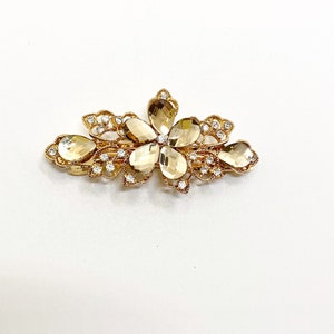 Champagne gold rhinestone flower leaf hair clip with central crystal.