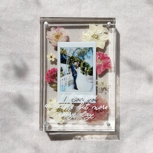 Acrylic photo frame with pressed flowers, custom lettering, and a single instant photo