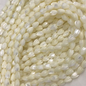 White pearl beaded strand with teardrop-shaped beads, close-up